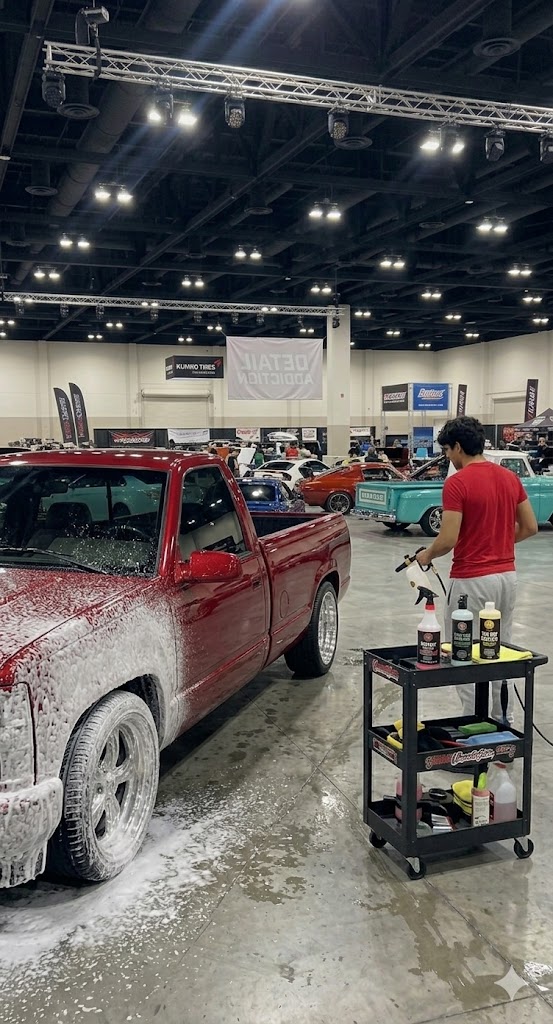 Red truck covered in foam wash at car show